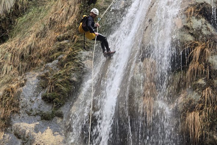 a person riding on the back of a waterfall