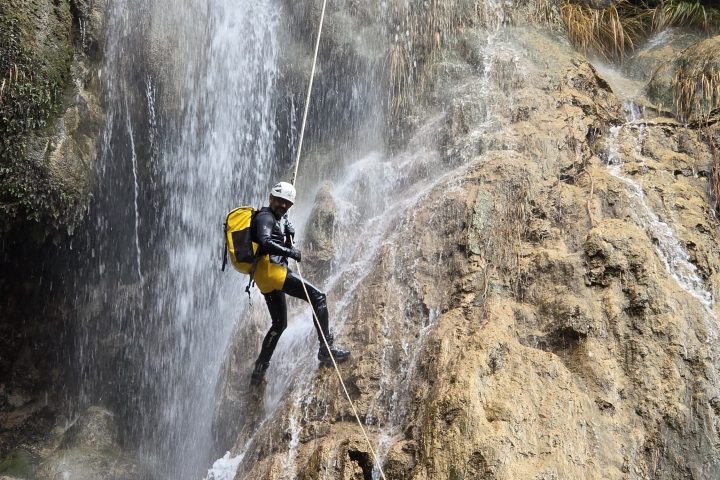 a man riding on the back of a waterfall
