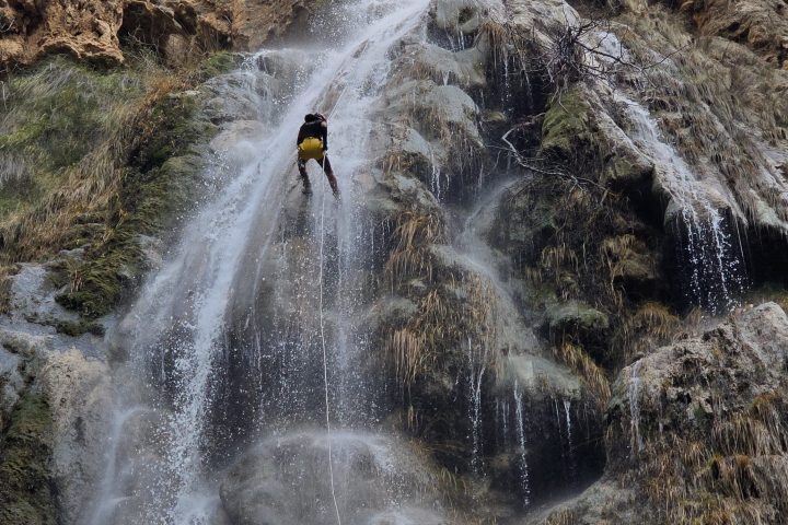 a large waterfall over some water