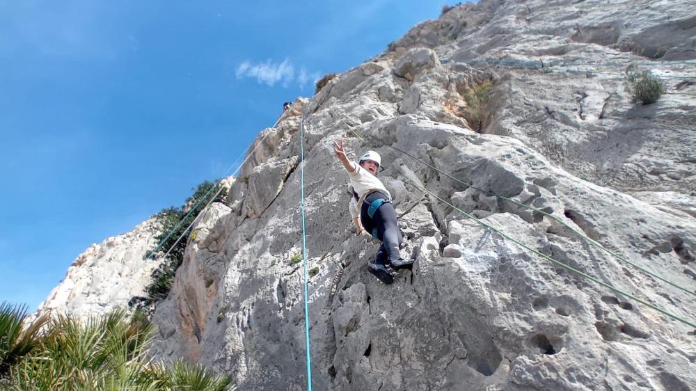 a man jumping in the air on a rocky hill