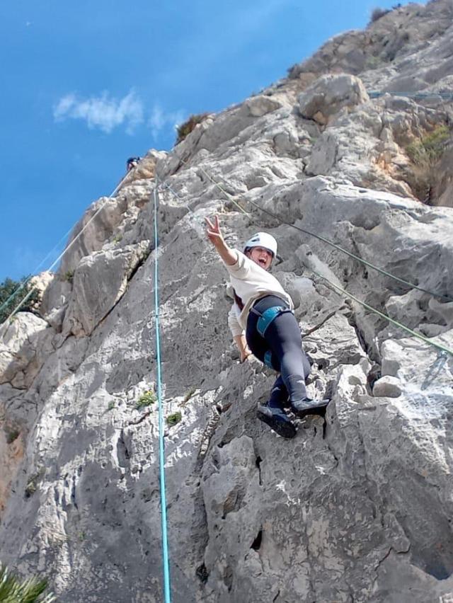 a man jumping in the air on a rocky hill