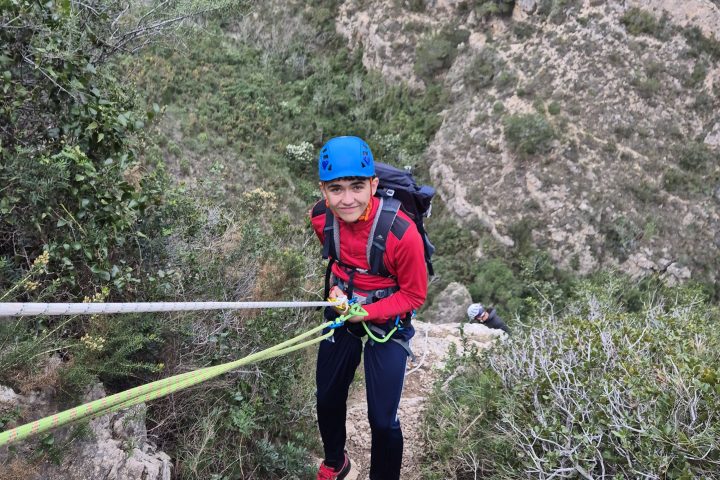 a man standing in front of a mountain