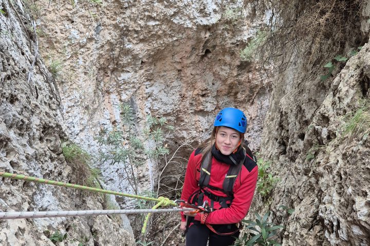a person standing next to a forest