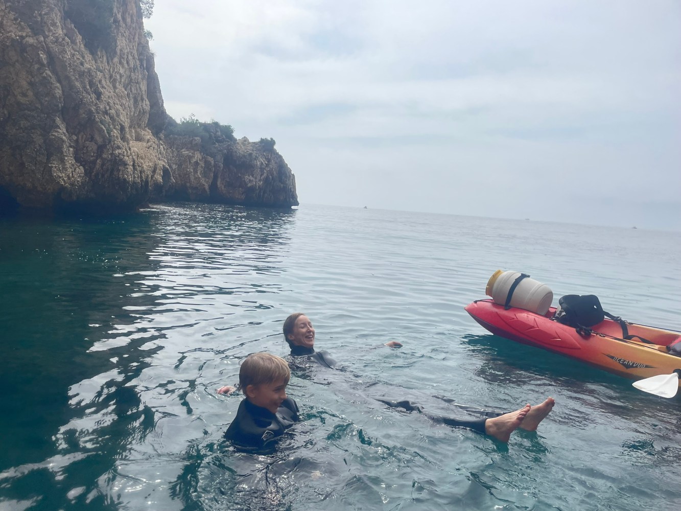 a group of people in a small boat in a body of water