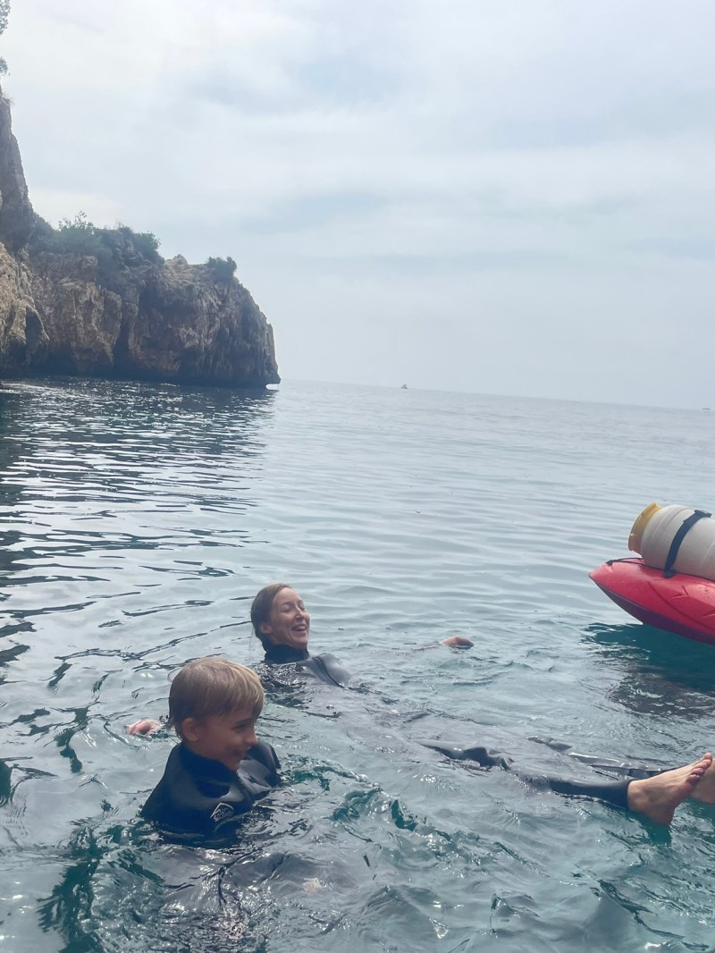 a group of people in a small boat in a body of water
