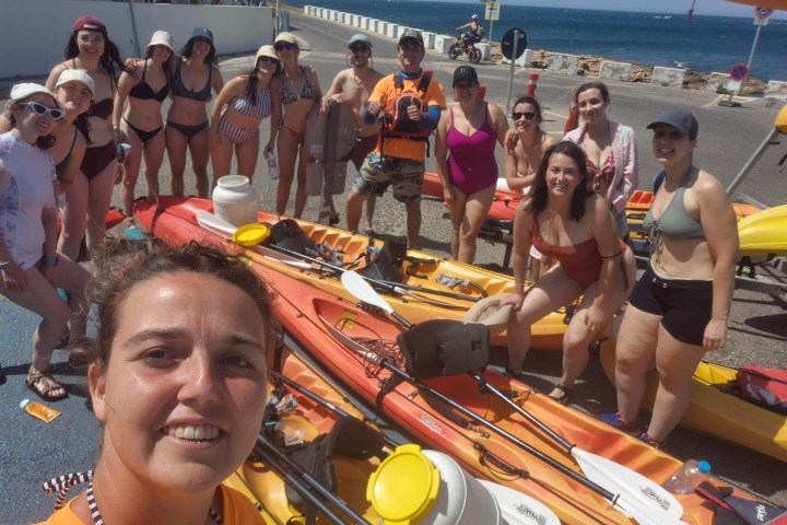a group of people on a boat posing for the camera