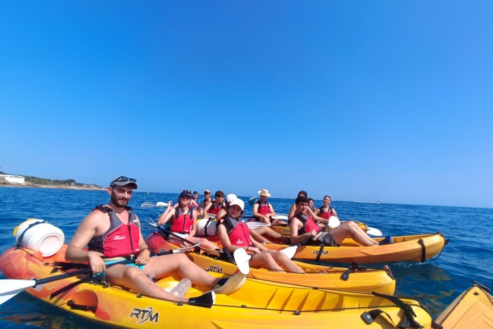 a group of people in a boat on a body of water
