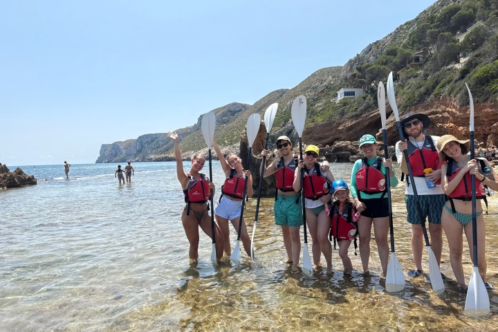 a group of people standing on top of a mountain