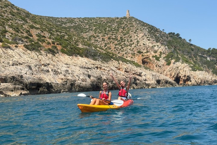 a group of people in a small boat in a body of water