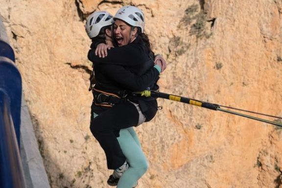 Dos participantes disfrutando del movimiento pendular tras el salto de puenting tándem en el Mascarat
