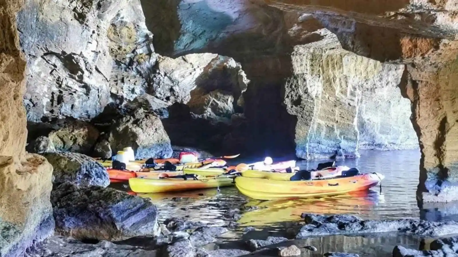 Kayaks inside Cova Tallada during a guided tour in the Cabo de San Antonio Marine Reserve